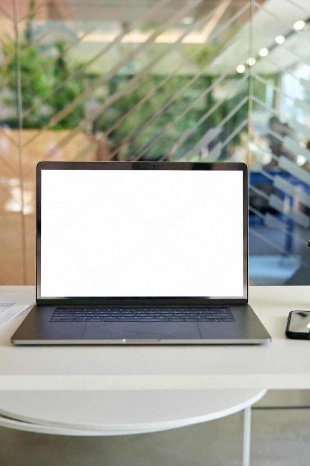 Open laptop with a blank screen on a bright desk, ready for a domain search